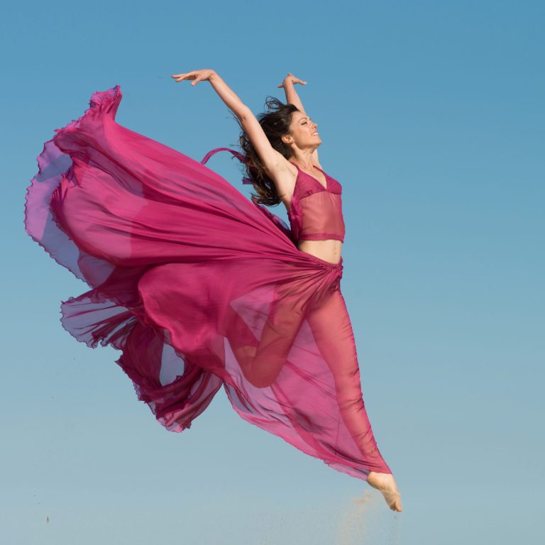 Woman,In,Airy,Crimson,Dress,Jumping,In,The,Air,,Blue